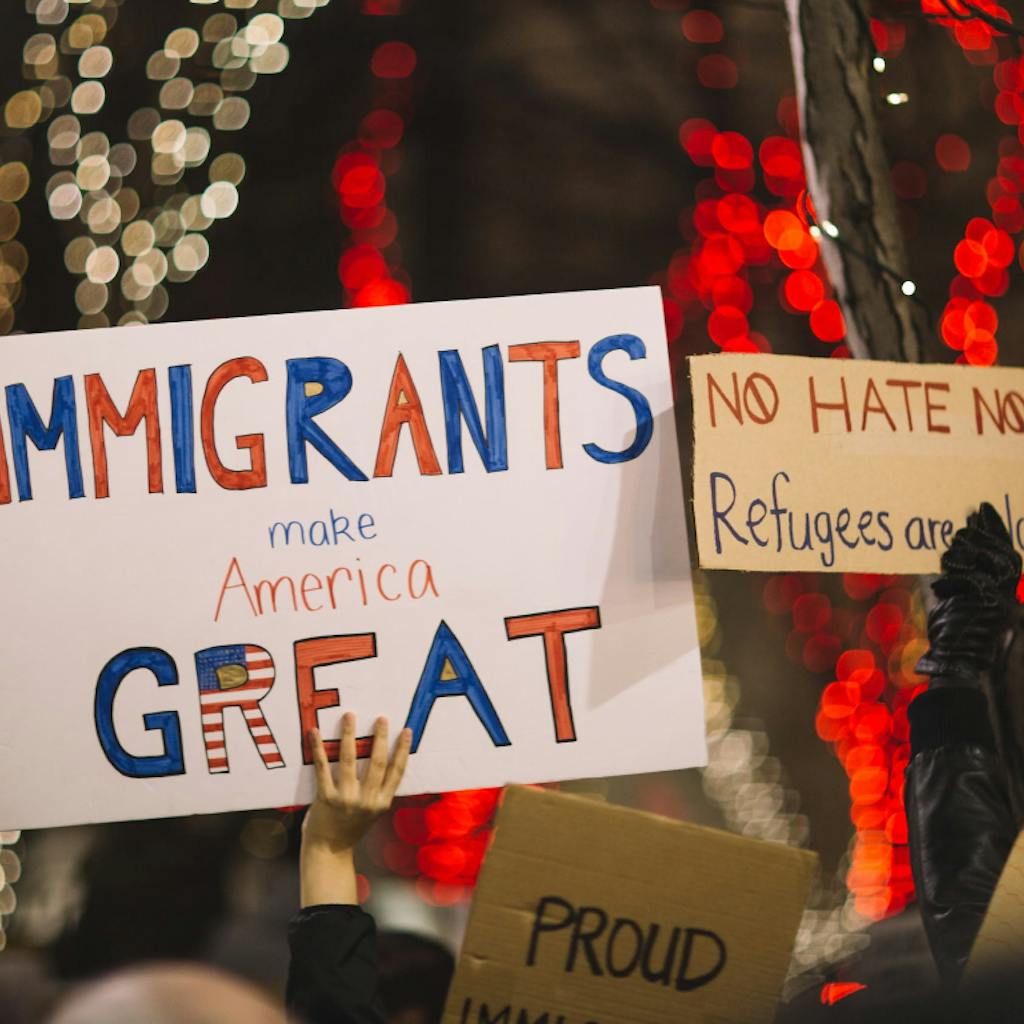 People protesting with banners and slogans supporting immigration