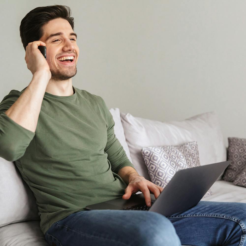 Smiling young man talking on mobile phone