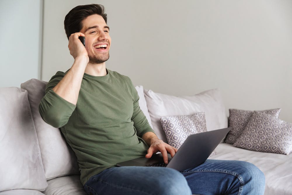 Smiling young man talking on mobile phone