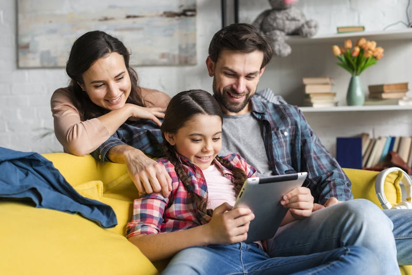 Happy family looking at a tablet