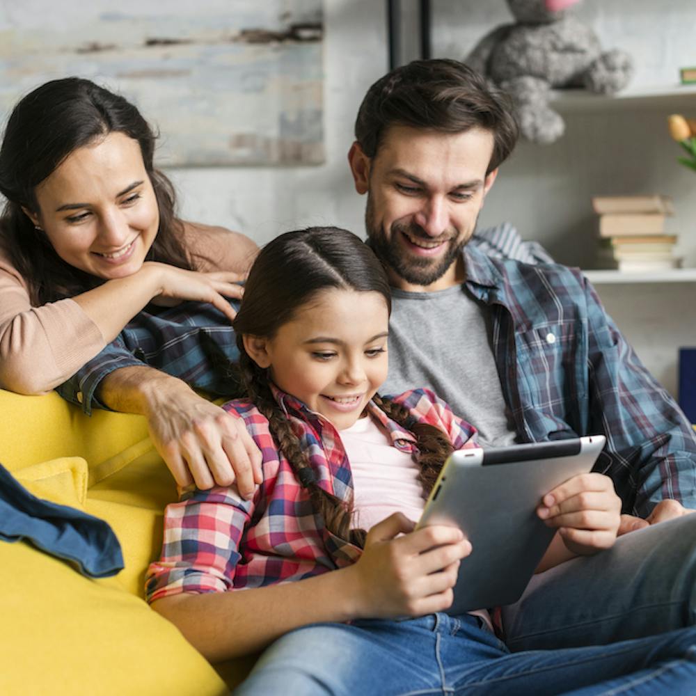 Happy family looking at a tablet