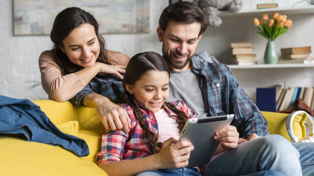 Happy family looking at a tablet