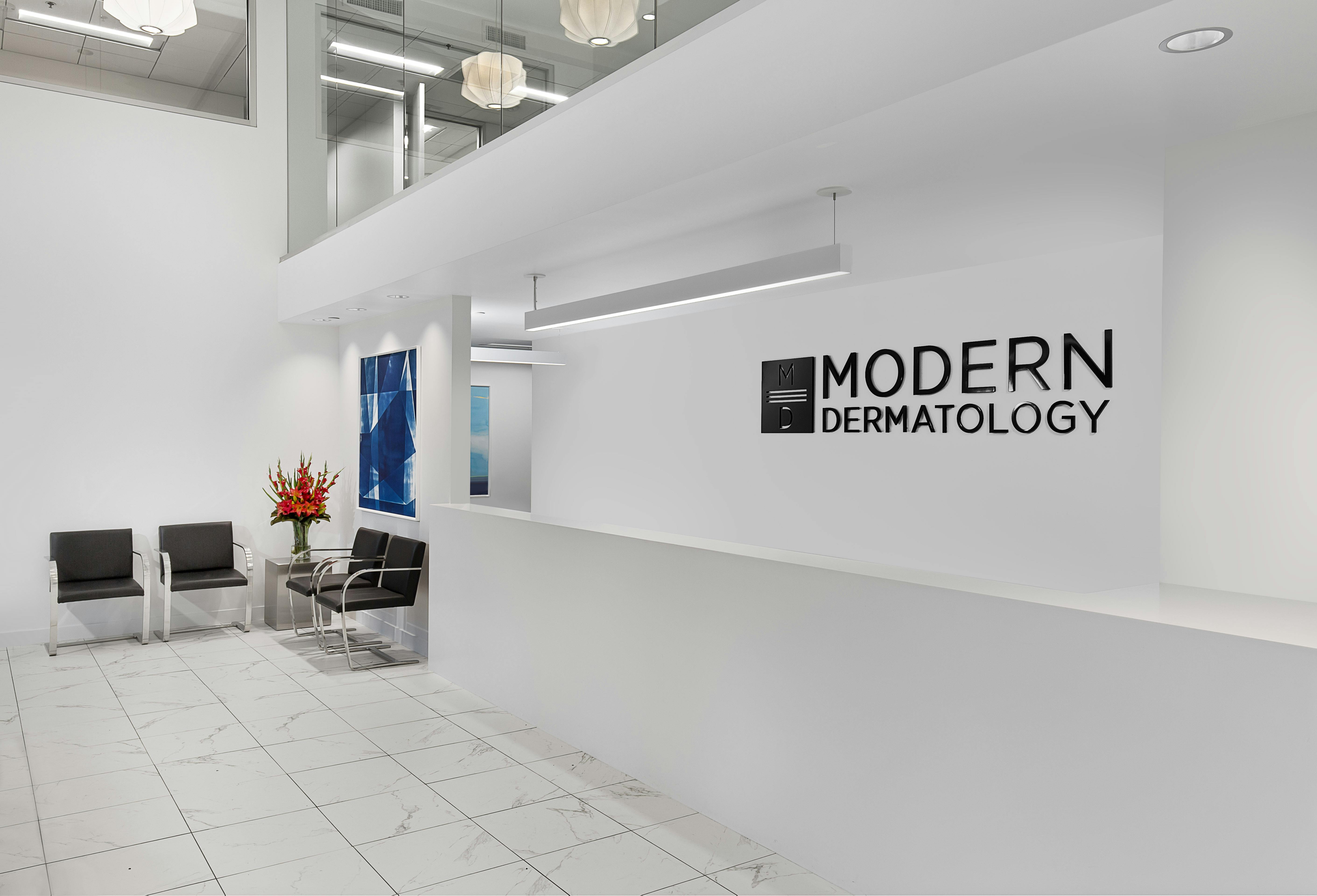 The clean and modern front desk and waiting area in the Modern Dermatology clinic. 