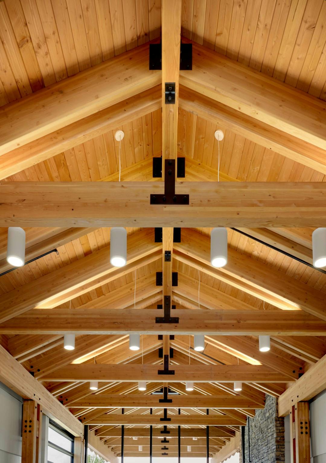 Vaulted ceilings in the entryway of the OOC ambulatory surgery center. The ceiling is composed of exposed wood and large glulam beams. 