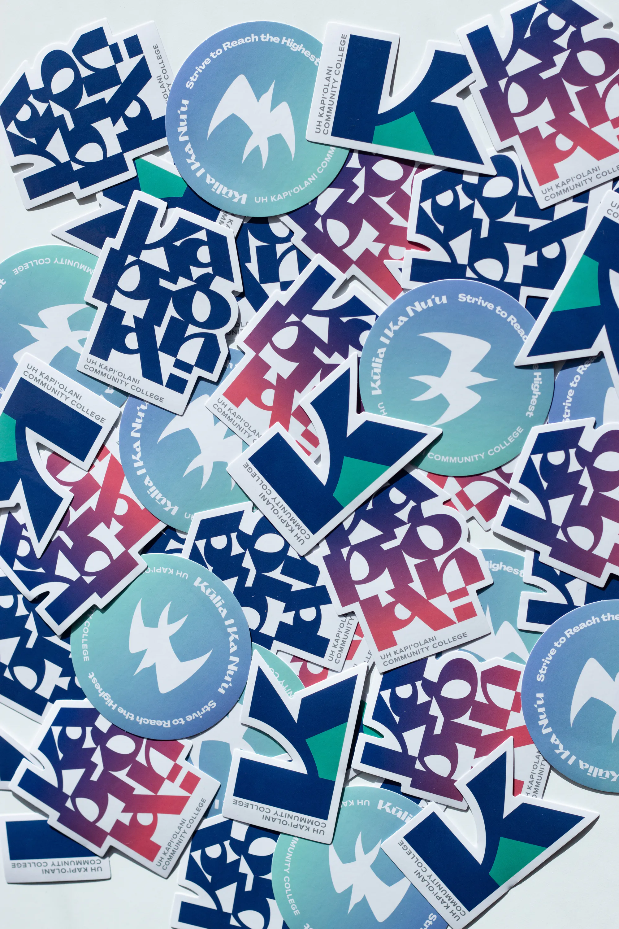 Above: Promo stickers featuring custom typography graphics, and the iconic bird that roots on campus, the manu o ku.