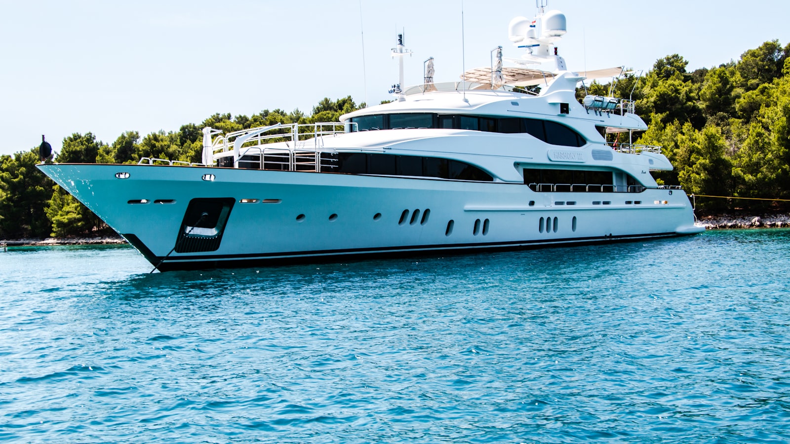 White catamaran sailing on clear blue water