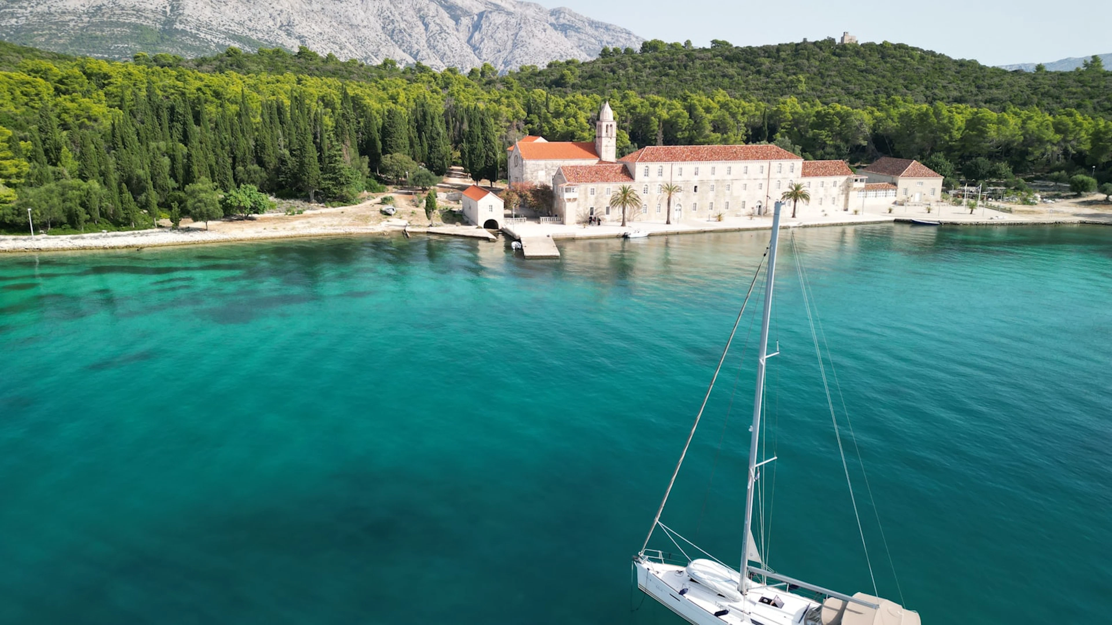 Sailboat anchored in a clear Adriatic bay near Korčula