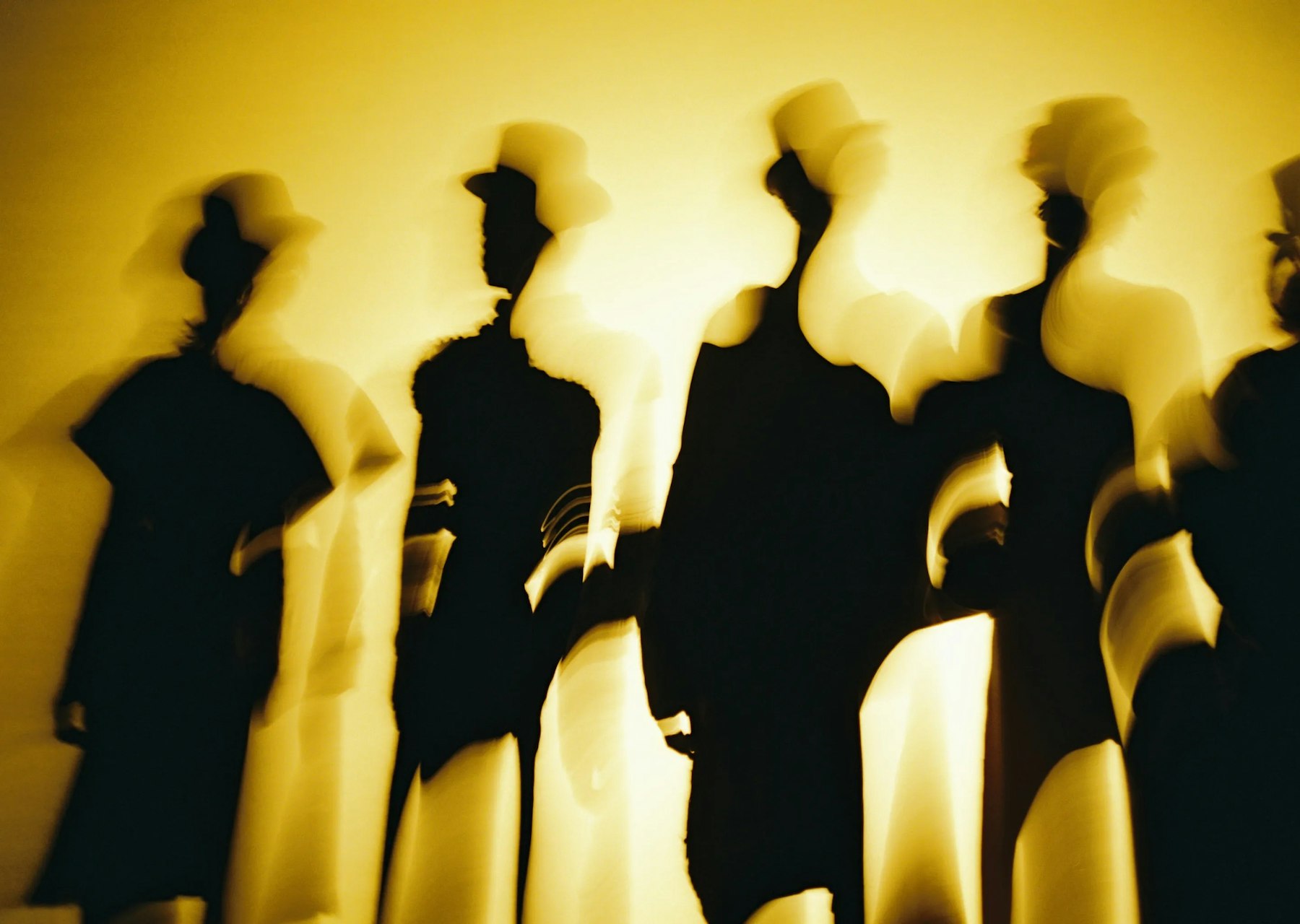 Blurry silhouettes of men wearing top hats