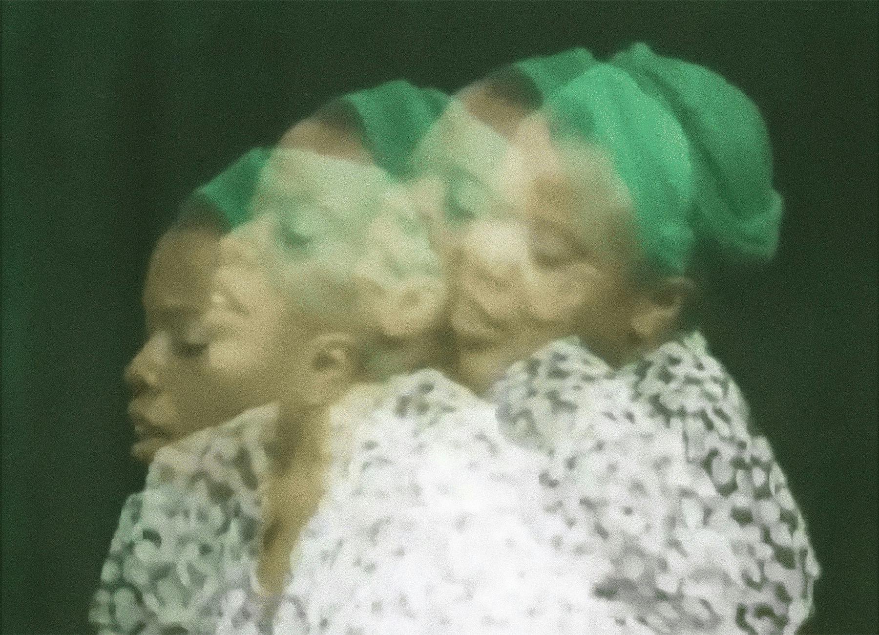 Blurry photo of woman wearing a green hat