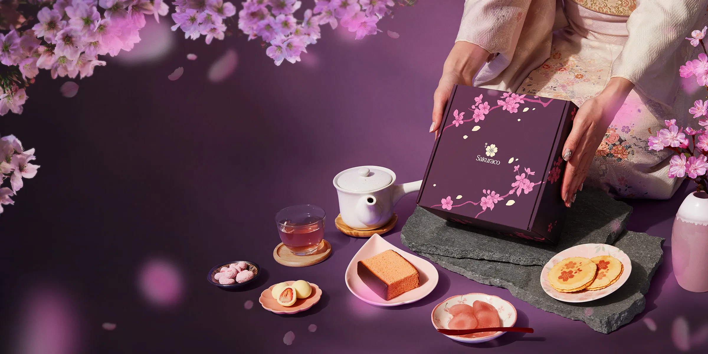 Sakuraco's April Box: A Night of Sakura displayed with Japanese snacks and sweets