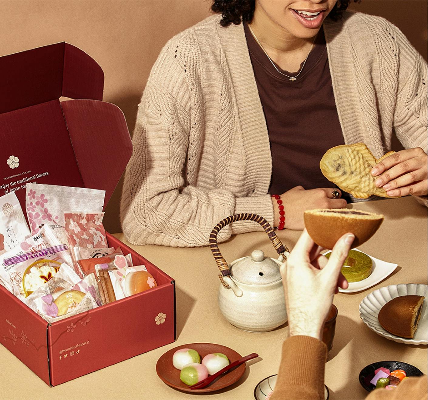 A woman enjoys taiyaki with friends