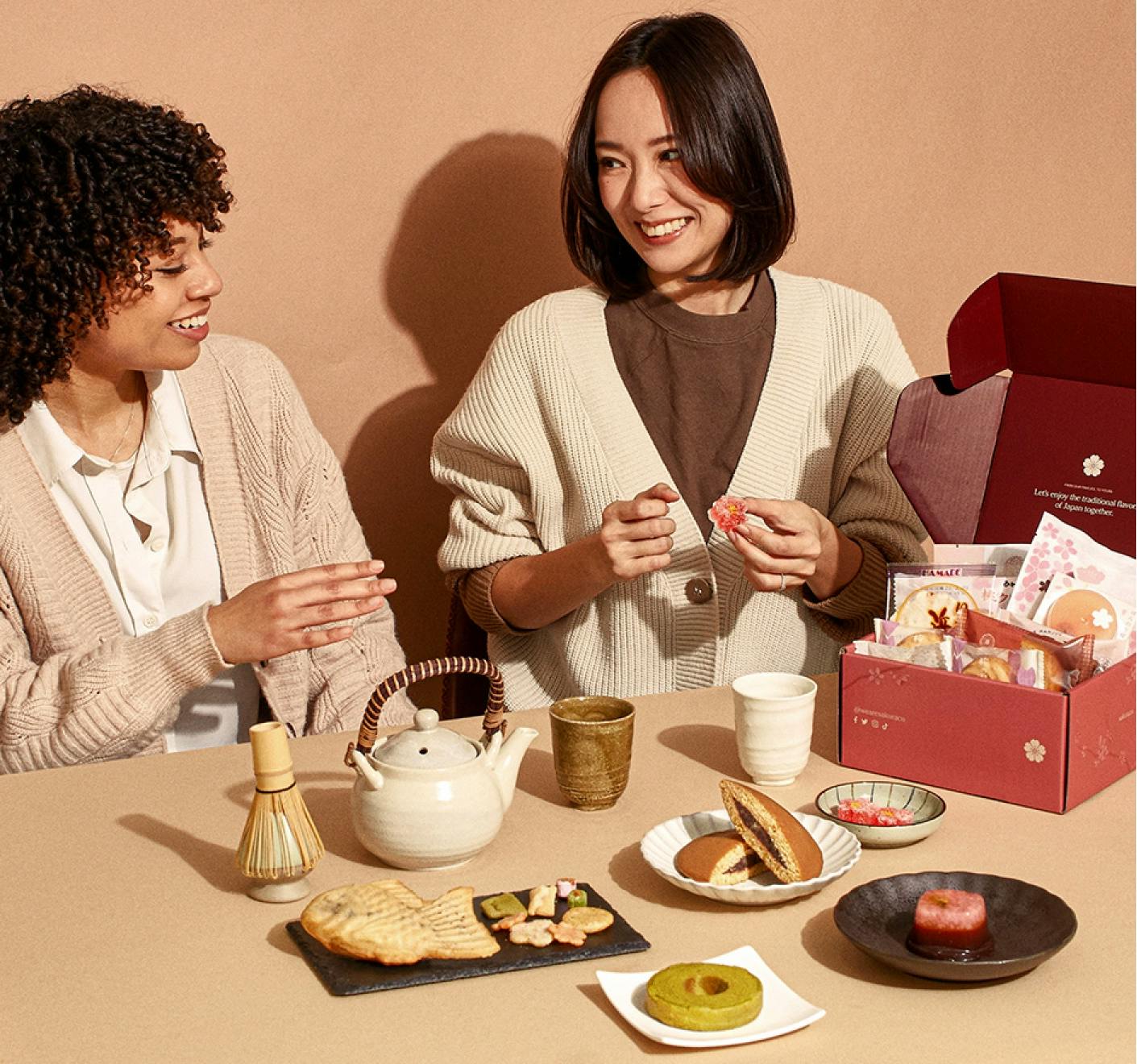 Ayumi Chikamoto sits with a friend to explain how to enjoy Sakuraco's snack box
