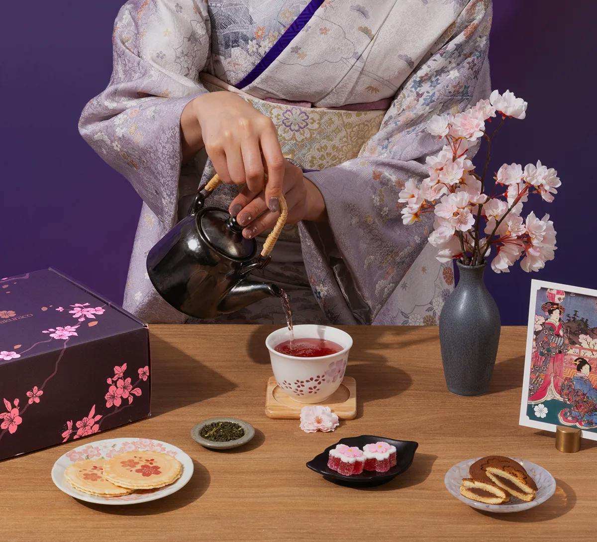 A woman in a kimono pours tea