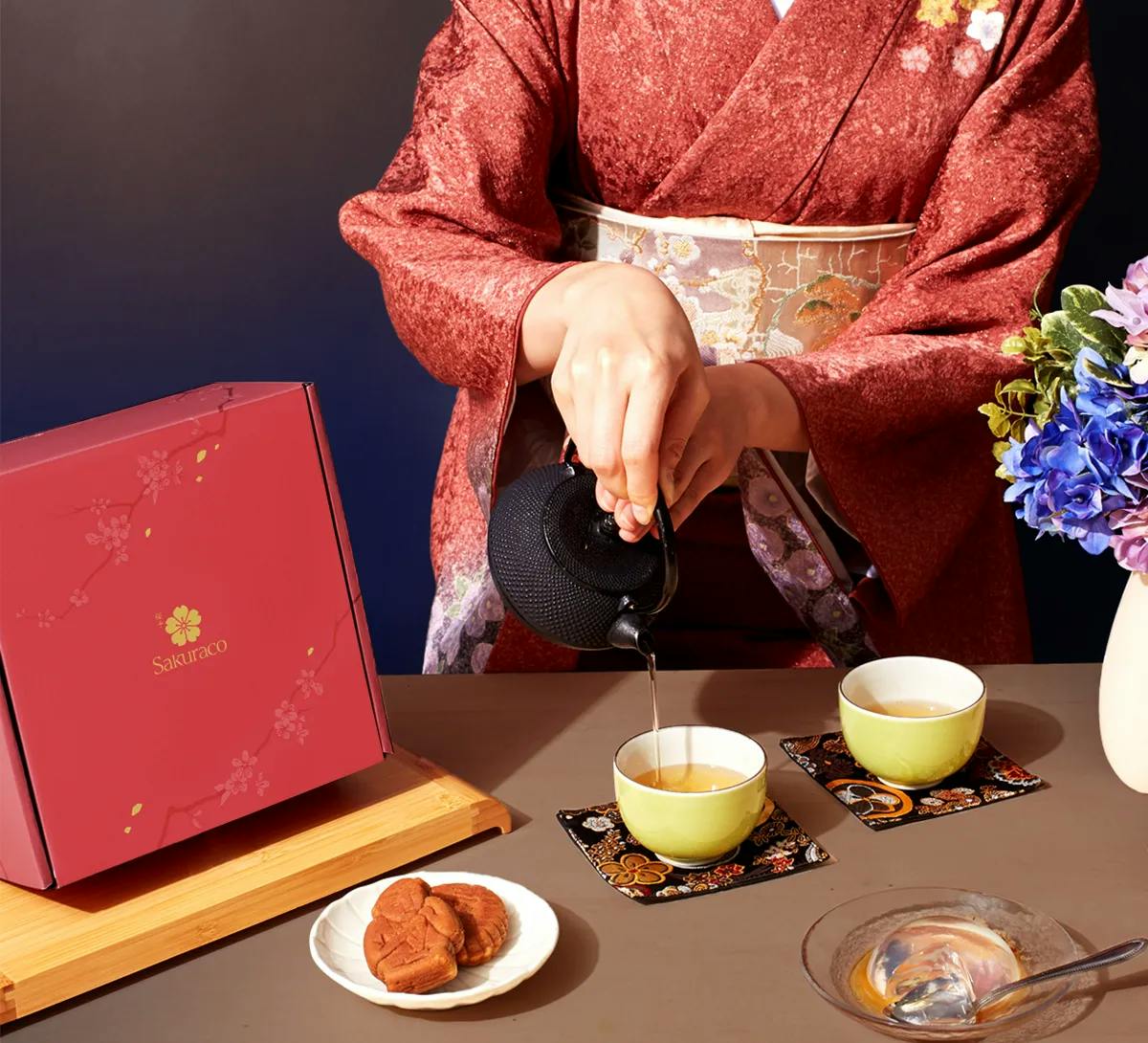 A woman in a kimono pours Japanese tea