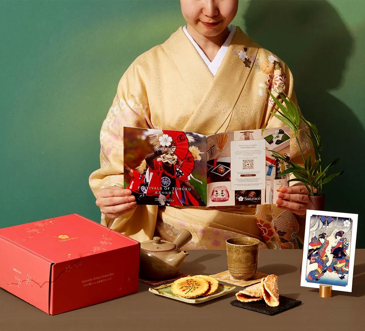 Woman in a kimono reads Sakuraco's culture guide