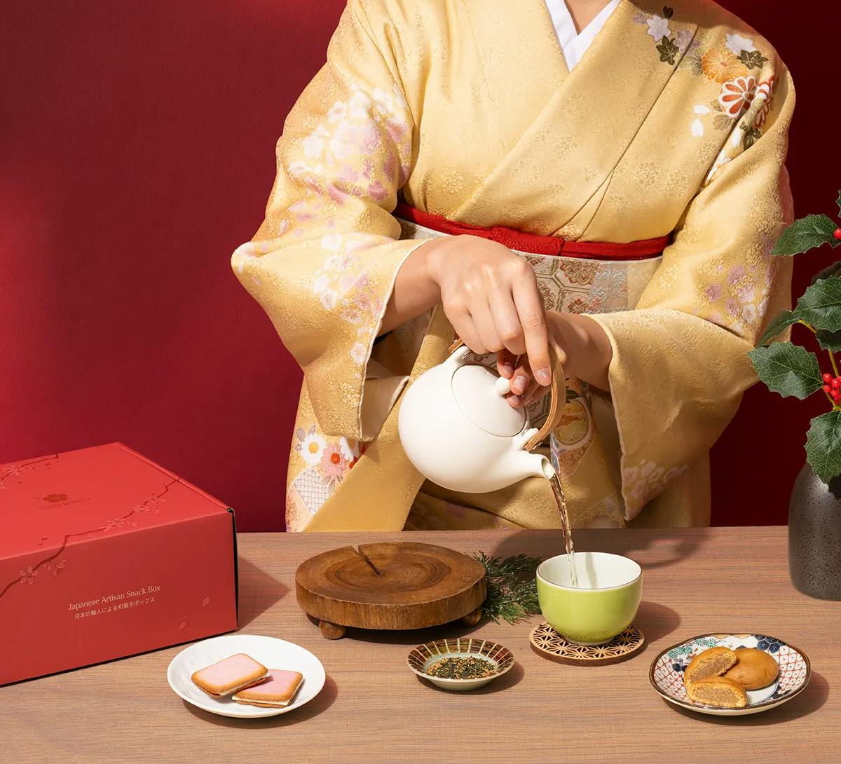 A woman in a kimono pours tea