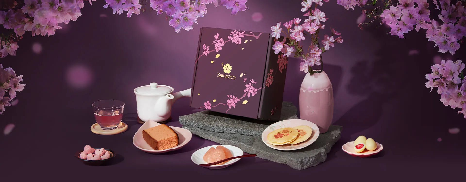Sakuraco's April Snack Box: A Night of Sakura, surrounded by cherry blossoms in a night setting.