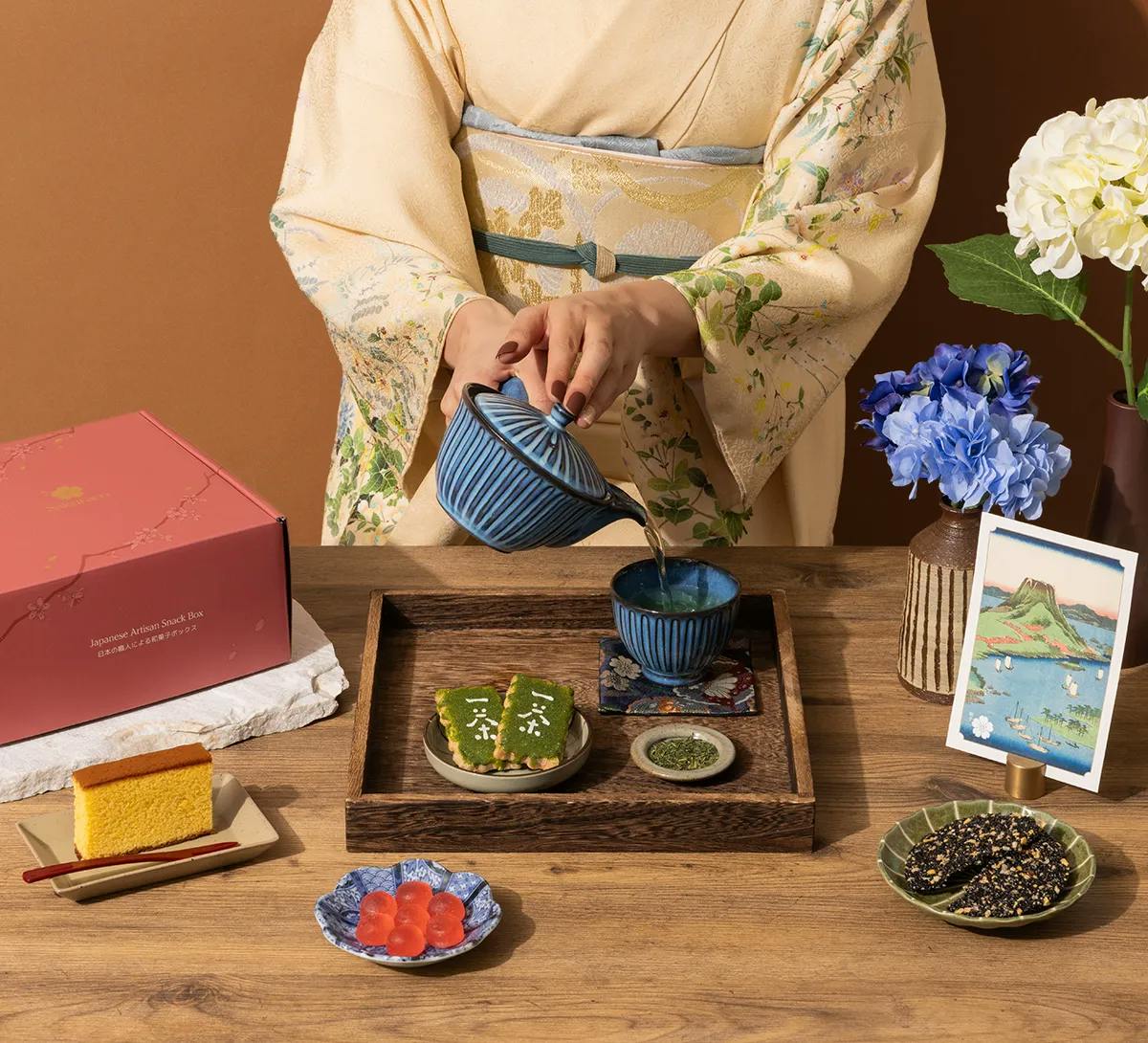 A woman in kimono pours tea