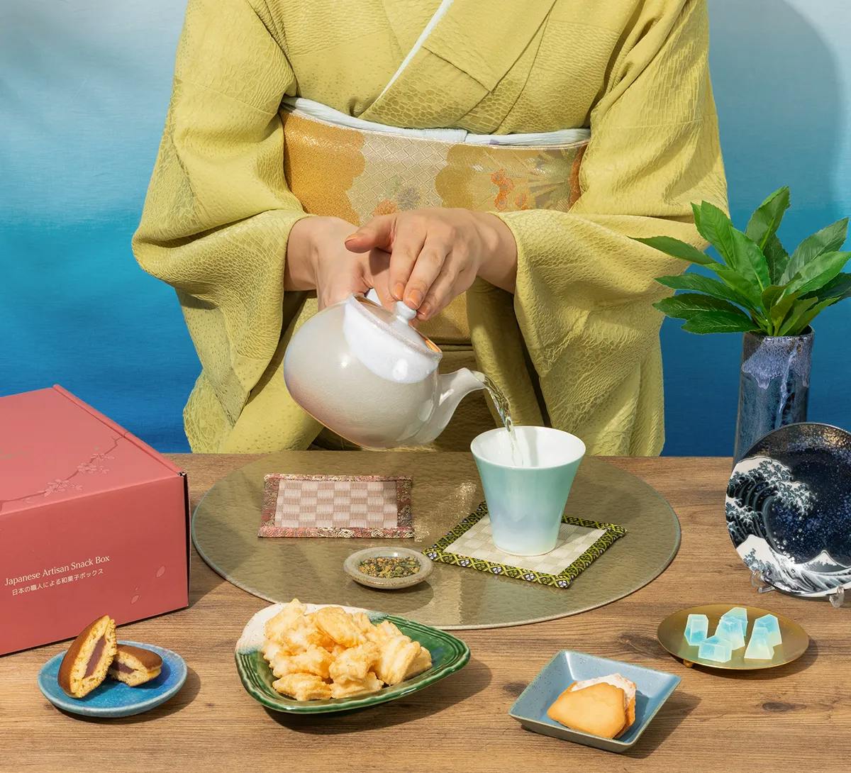 A woman pours tea in a kimono