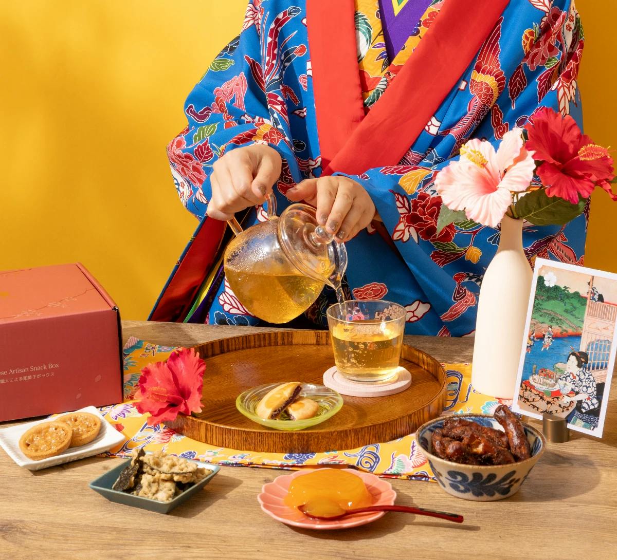Woman in traditional Okinawa kimono pours Japanese tea