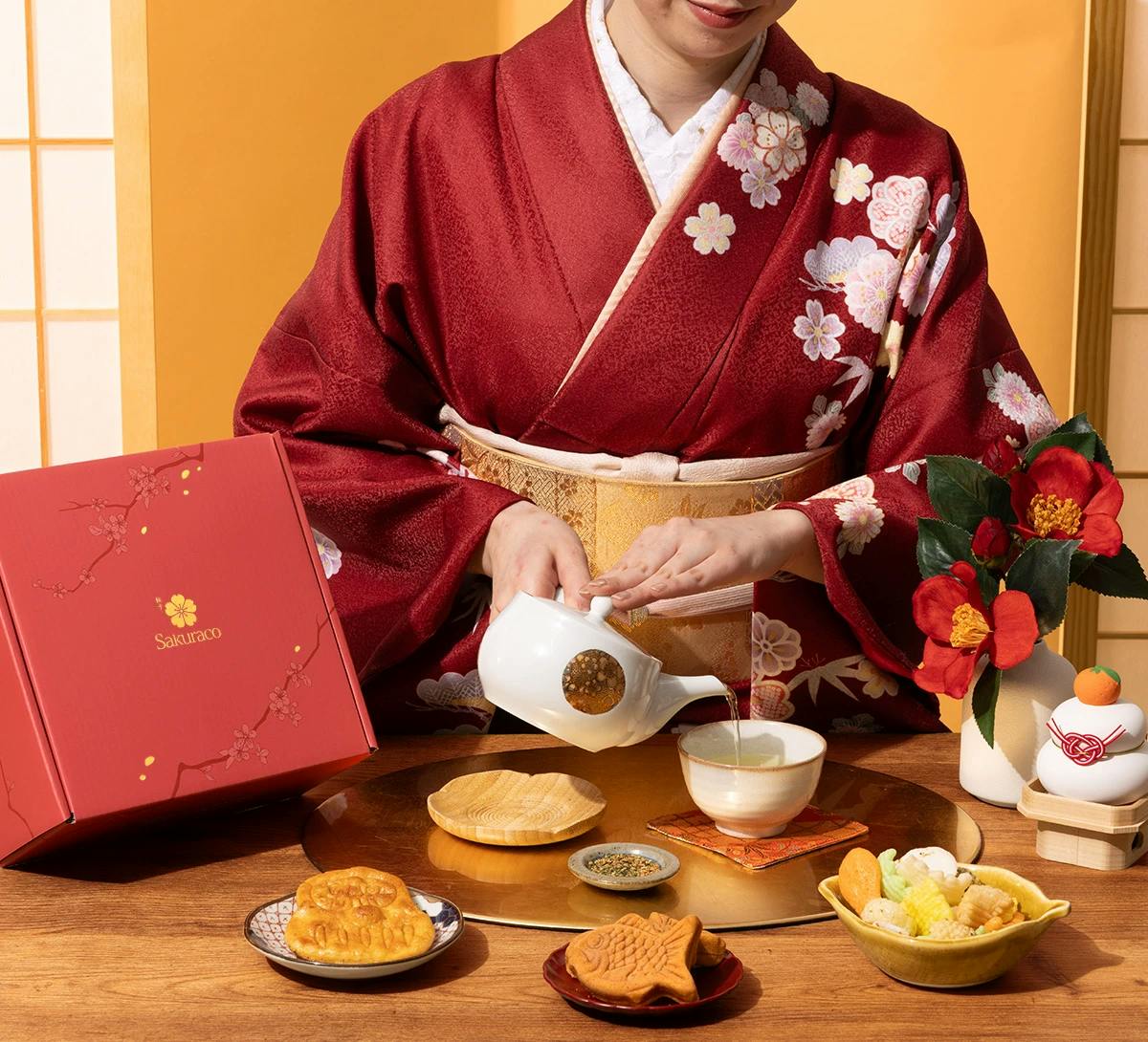 A woman in kimono enjoys Japanese wagashi snacks from Sakuraco.