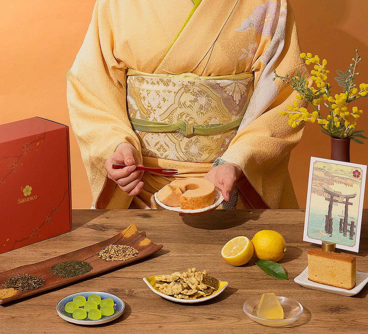 A woman in kimono enjoys Japanese wagashi snacks from Sakuraco.