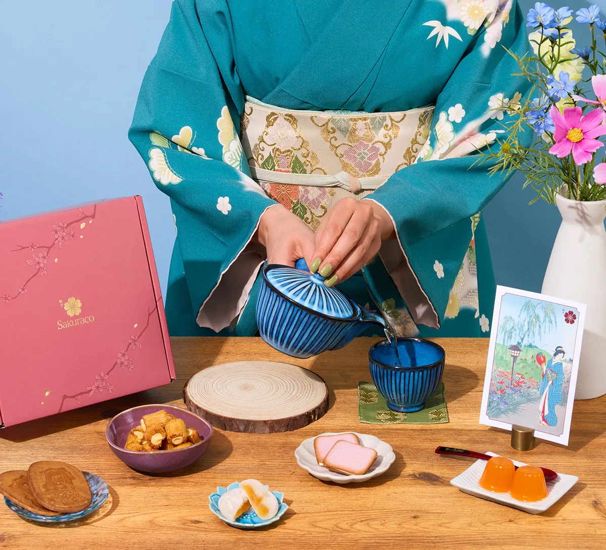 A woman in kimono enjoys Japanese wagashi snacks from Sakuraco.
