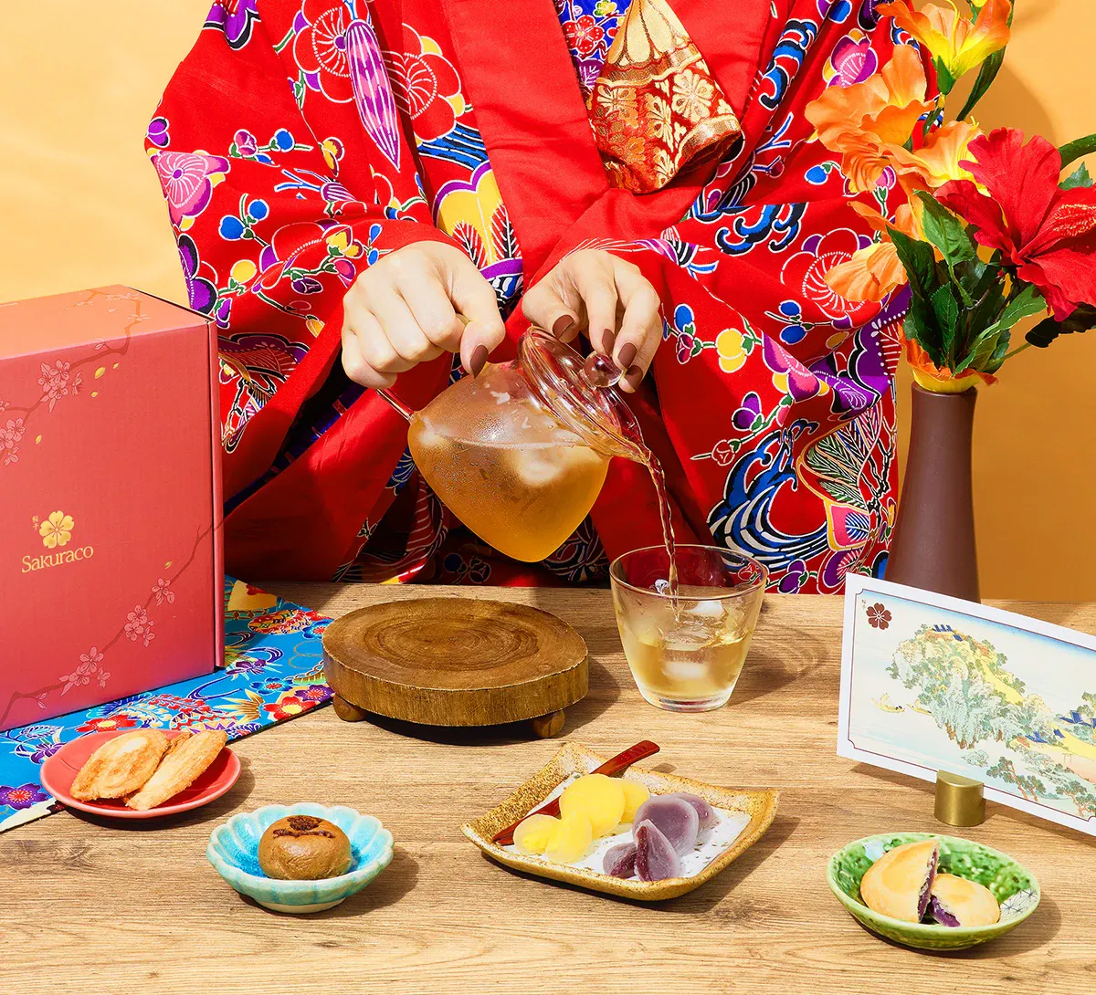 A woman in kimono enjoys Japanese wagashi snacks from Sakuraco.