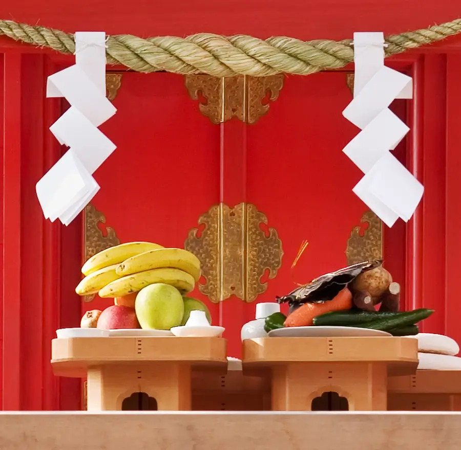 Fruit sits on a Shinto shrine as offerings.