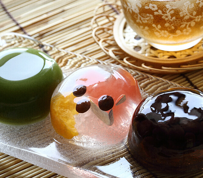 A set of three globes of Japanese jelly sit on a plate.