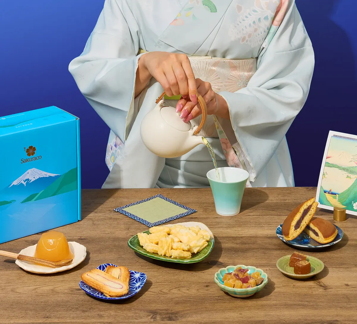 A woman in kimono enjoys Japanese wagashi snacks from Sakuraco.