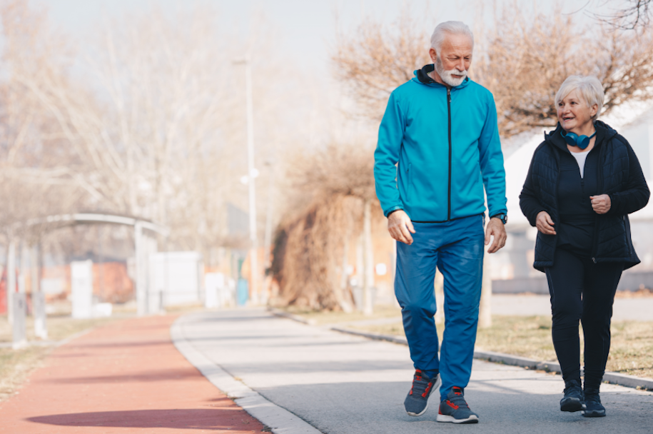 Image of an elderly man and woman walking together outside
