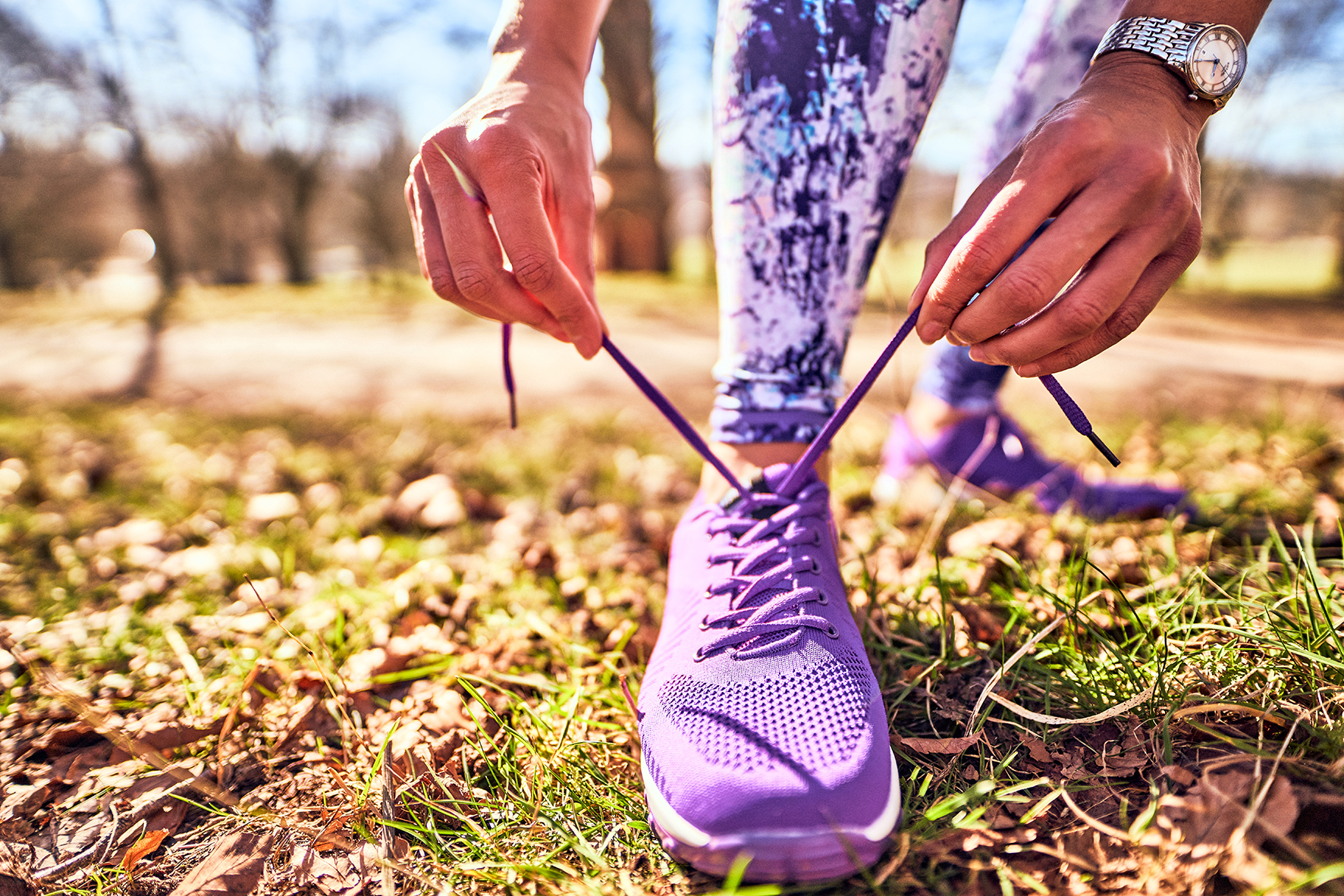 Close up image of a woman tying her shoe laces
