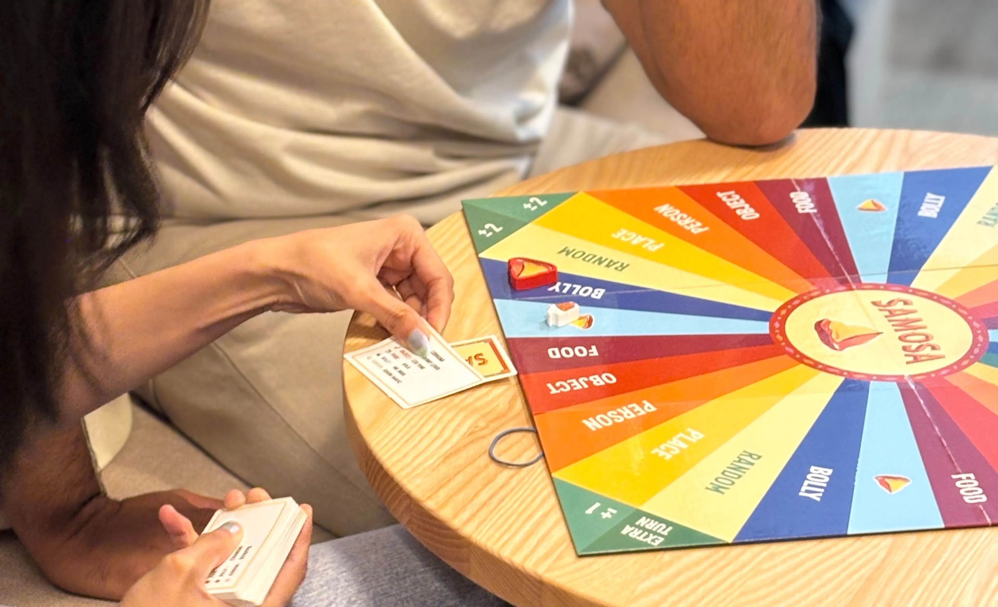 SAMOSA game board with colorful spinner and cards