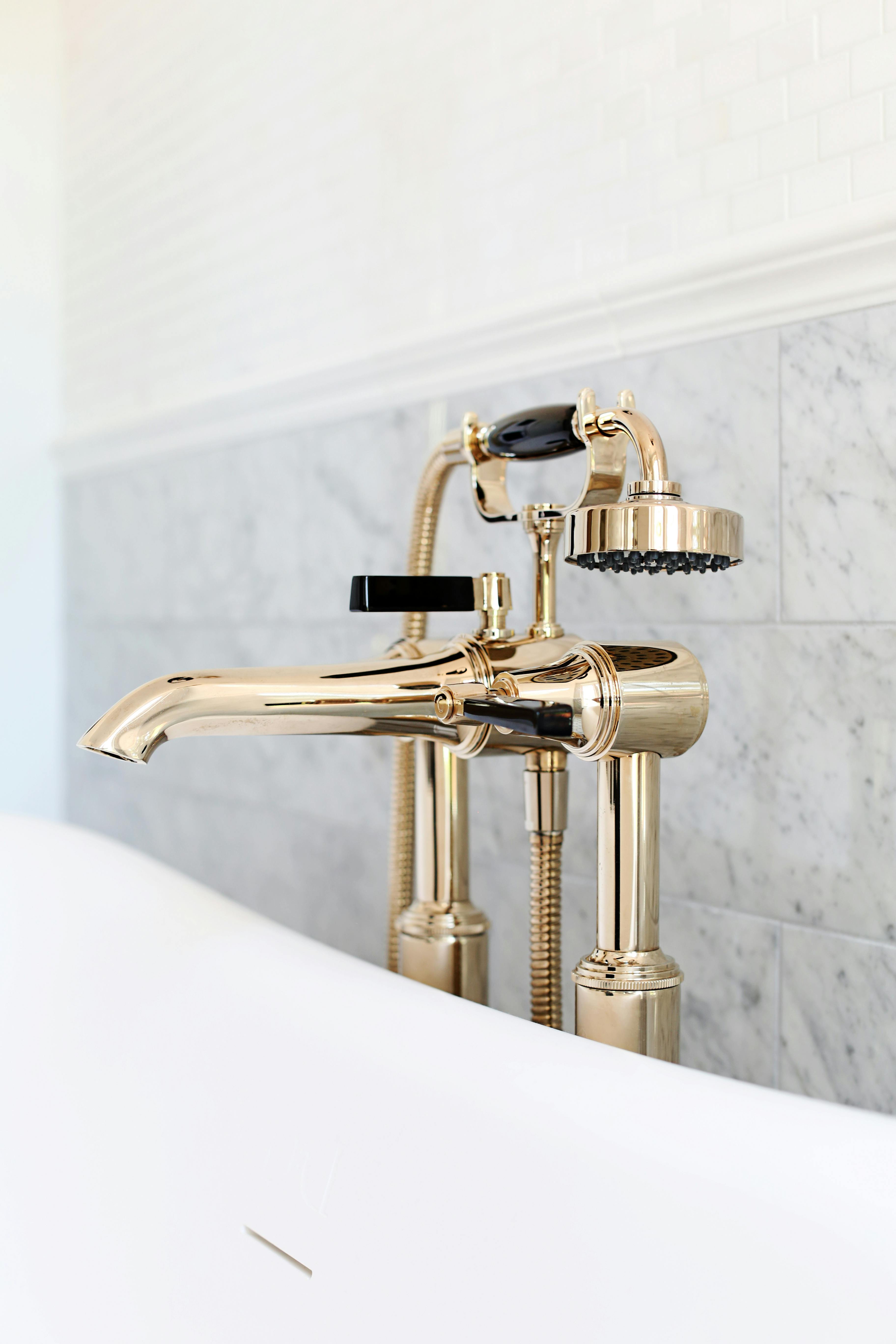 Antique Gold luxury Art Deco taps beside a bathtub