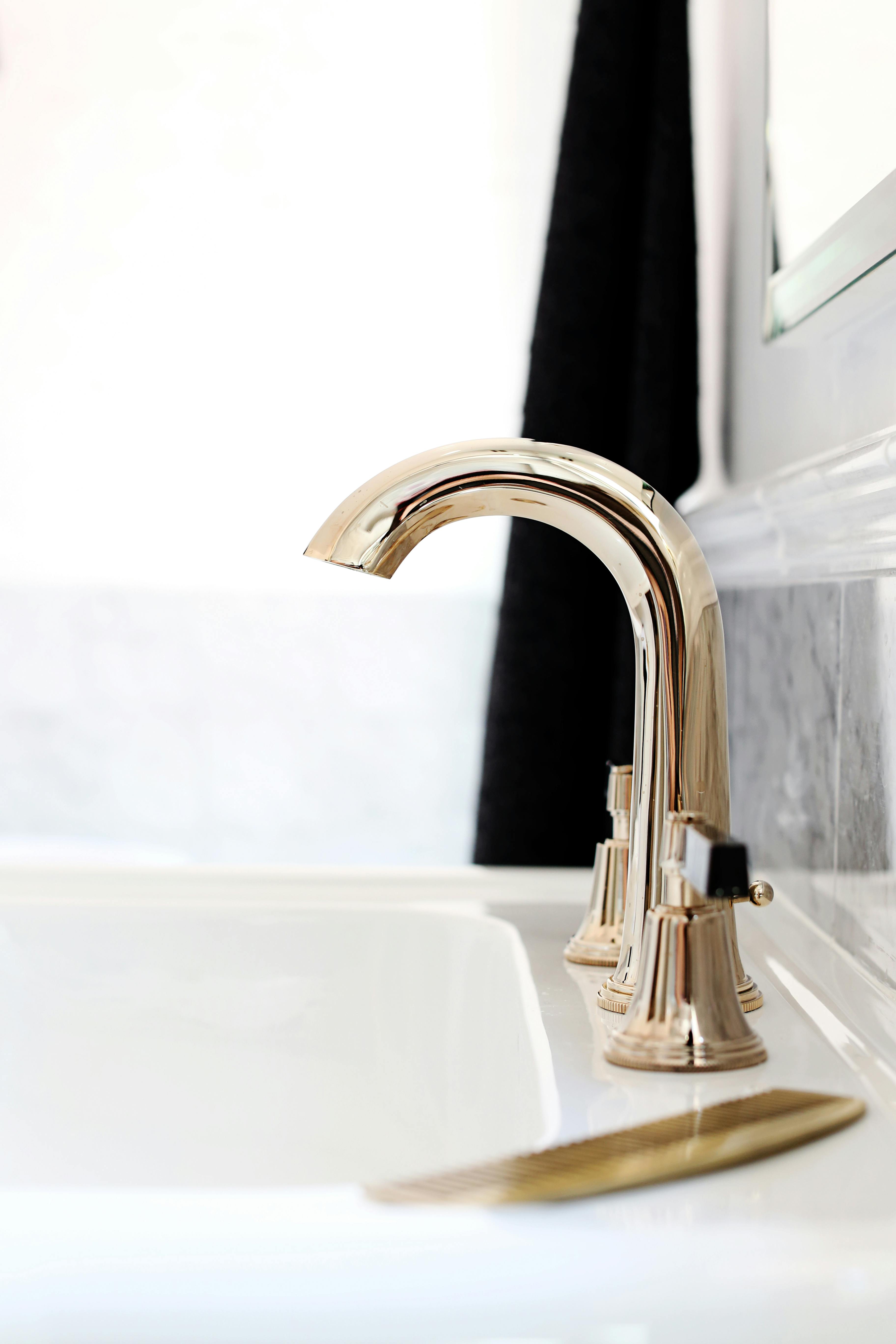 Luxury Art Deco taps mounted on a white basin
