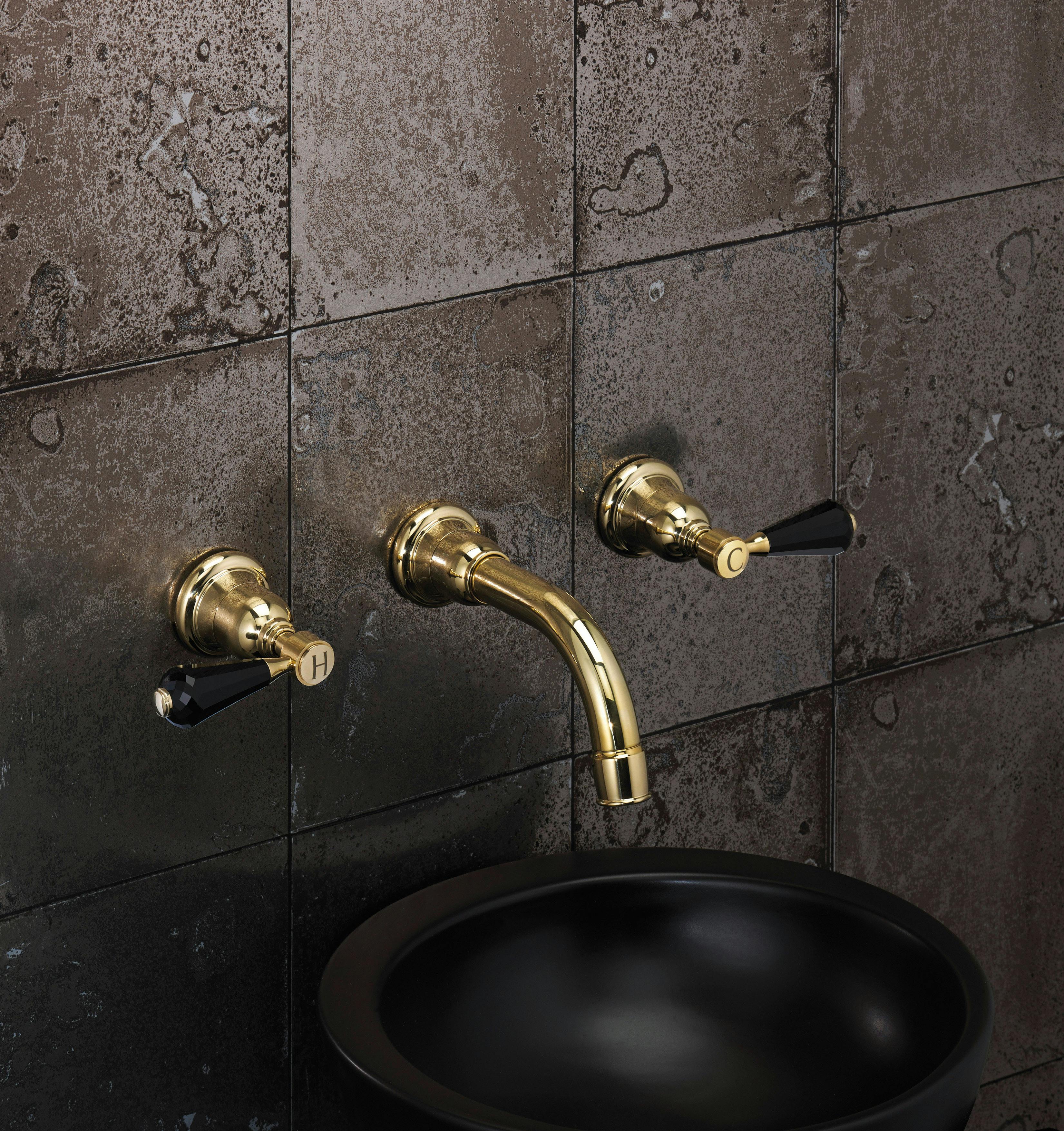 Samuel Heath wall mounted unlacquered brass tap. Traditional Fairfield collection with black crystal levers.