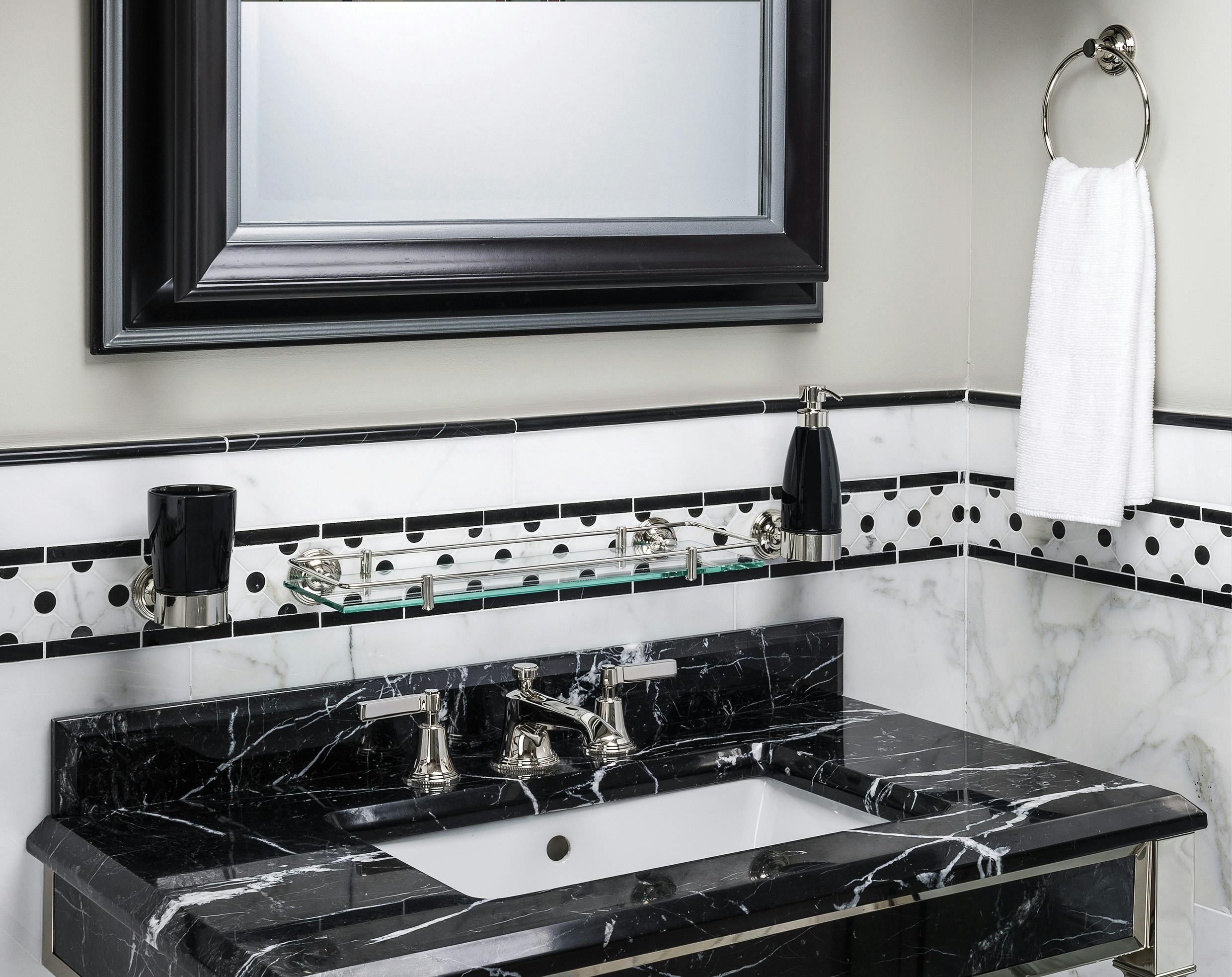 Luxury Art Deco taps mounted on a black marble basin