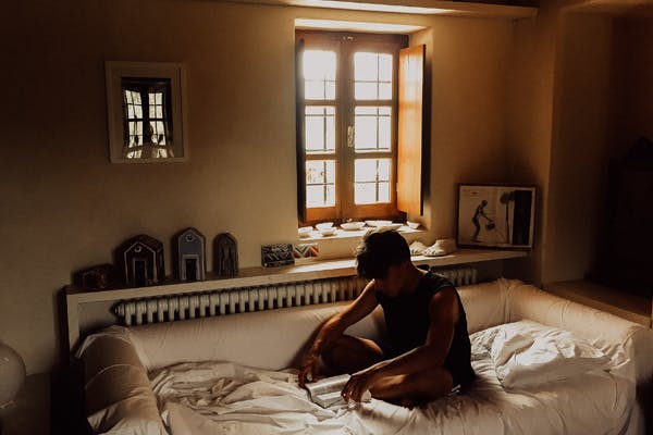 man sitting sleeping on the couch - finding the best ac temperature
