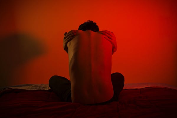 man trying to comfort himself to sleep
