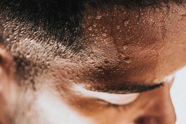 man sweating - hot air makes it hard to sleep