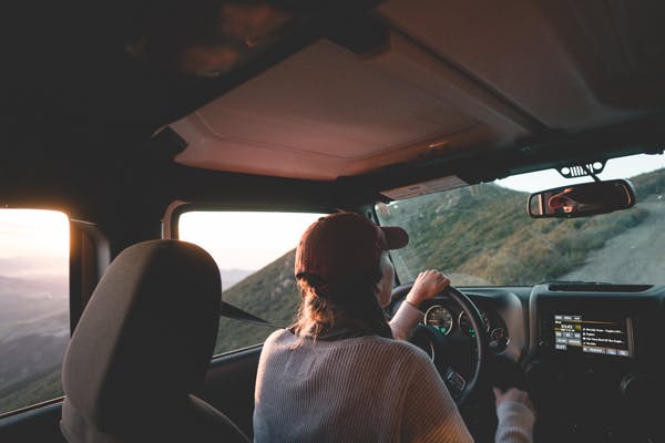 woman driving two people can sleep comfortable in the back seat of a car