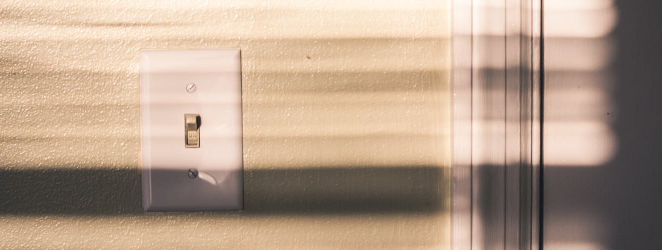 light switch with shadows cast by the rising sun