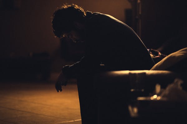 what is jet lag - man sitting on chair in the dark