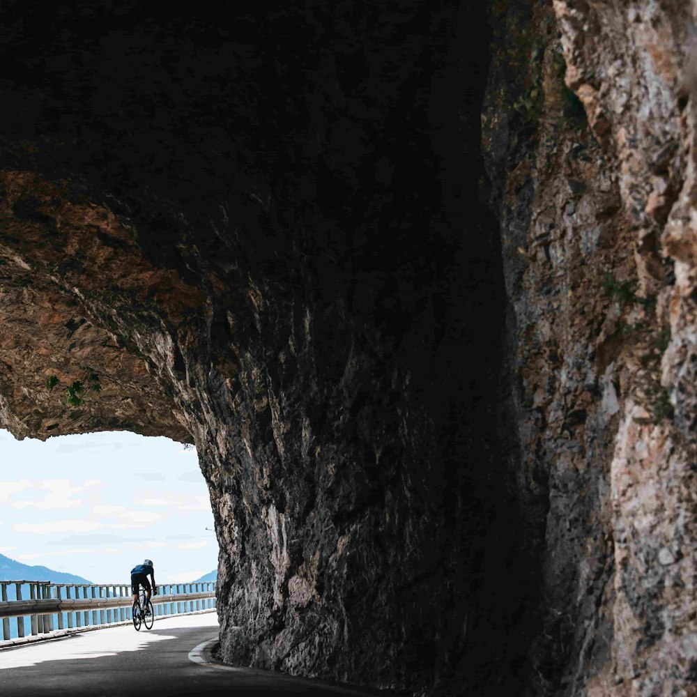 Riding on a road near a rock overhang