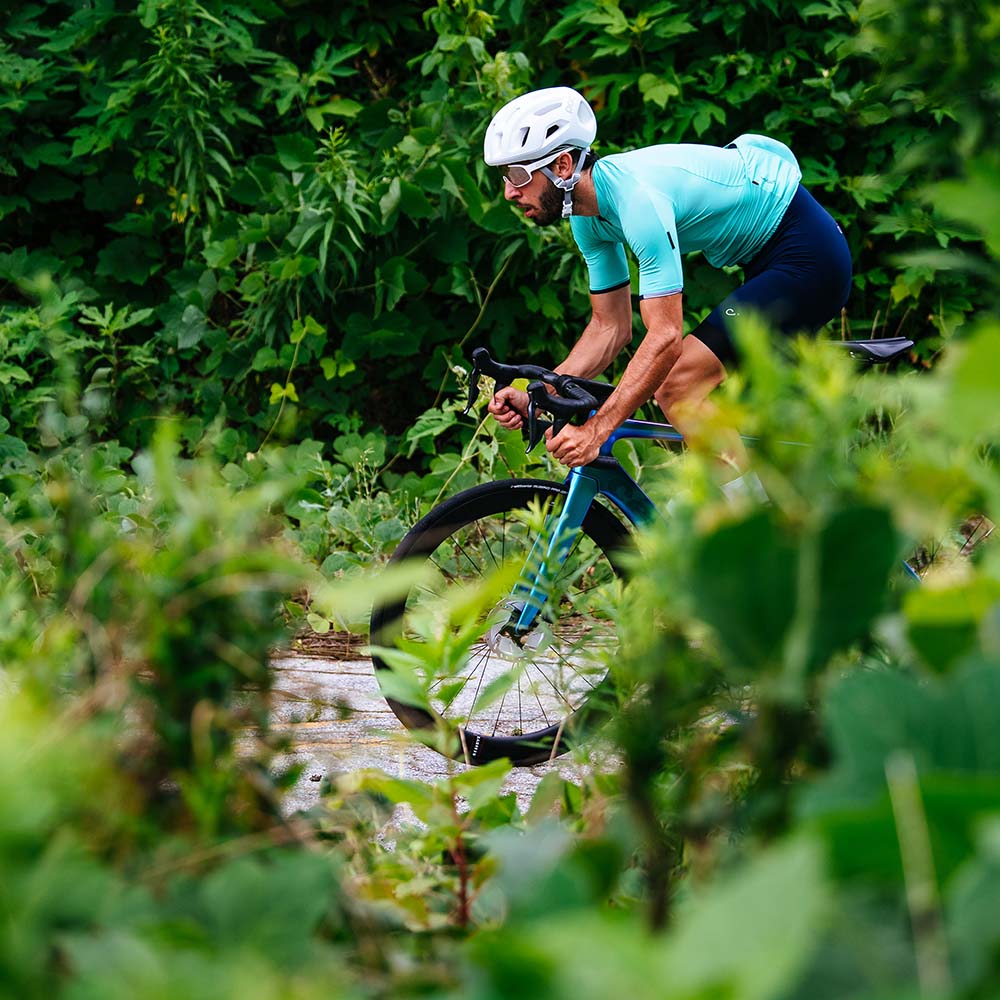Cyclist in blue jersey riding an aero bike