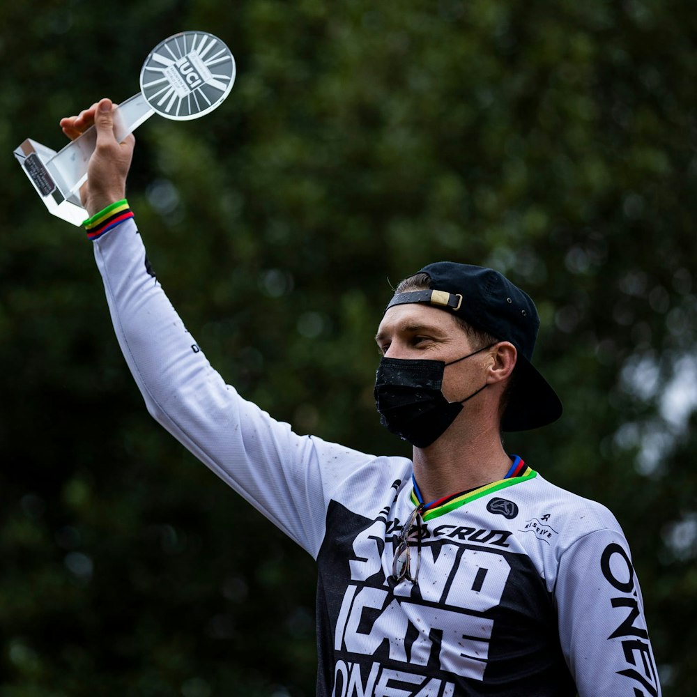 Greg Minnaar holding up his UCI trophy