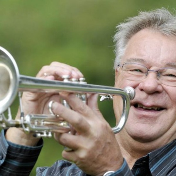 Derek Watkins profile photo, playing the trumpet.