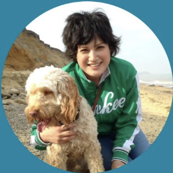 Sayako Grace Robinson smiling with a dog.