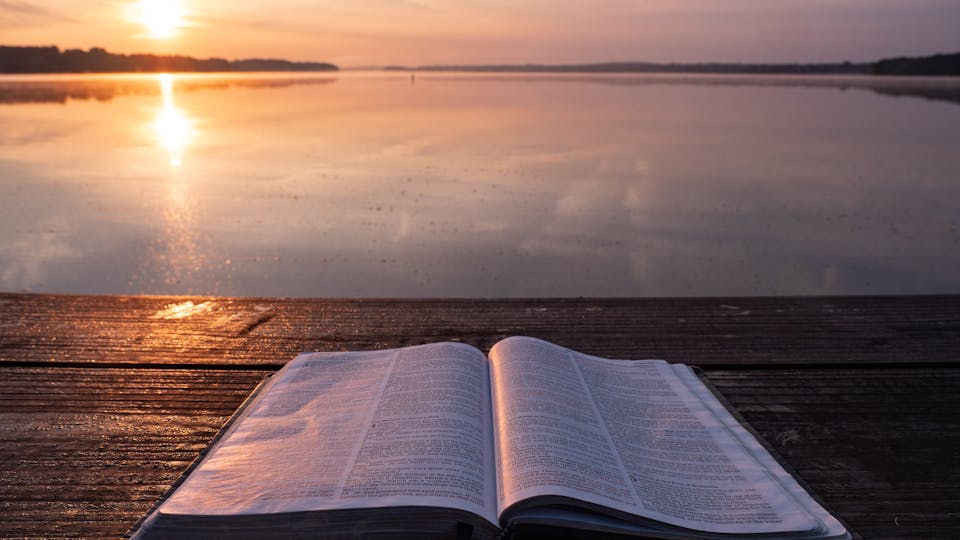 Bible opened in the sunset